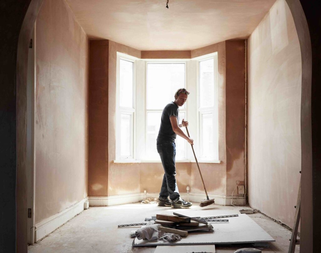 A photo of a builder cleaning up during a home renovation project.